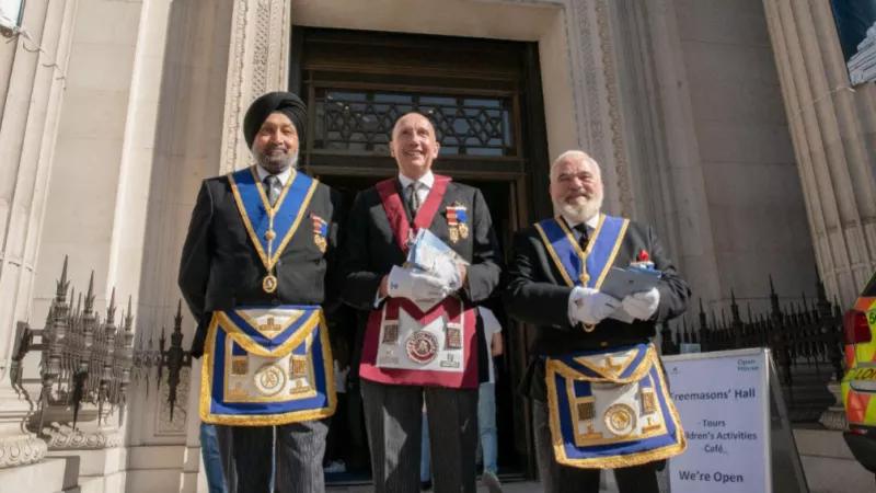 Three Freemasons welcoming the public at Freemasons' Hall at the Open House London 2022