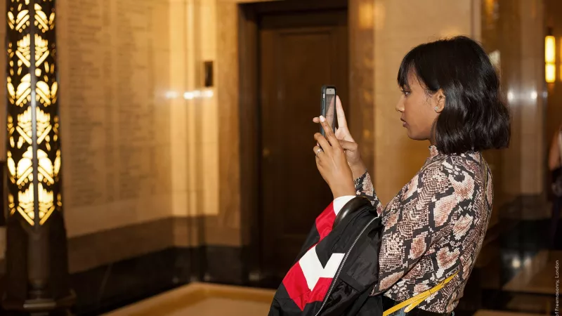 A visitor taking a photo during the tour at Freemasons Hall in London
