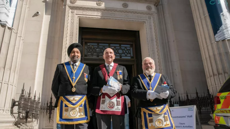Three Freemasons welcoming the public at Freemasons' Hall at the Open House London 2022
