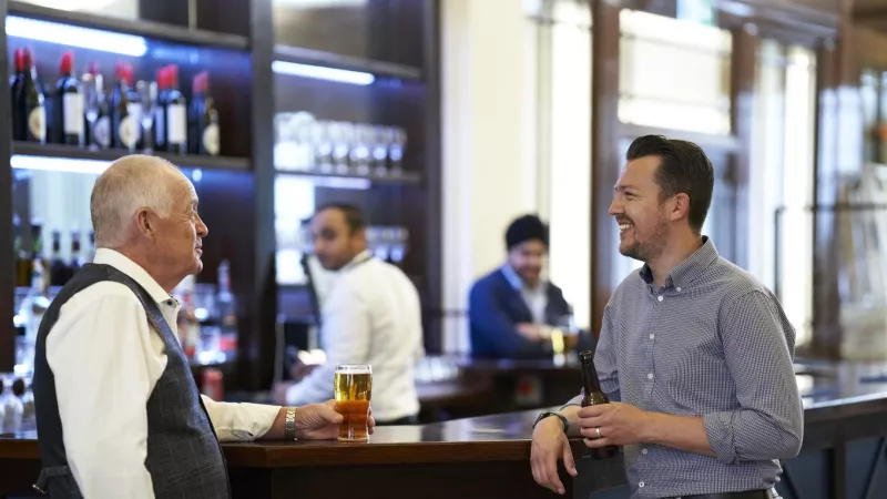 Two Freemasons are enjoying a beer at the Café and Bar at Freemasons Hall in London