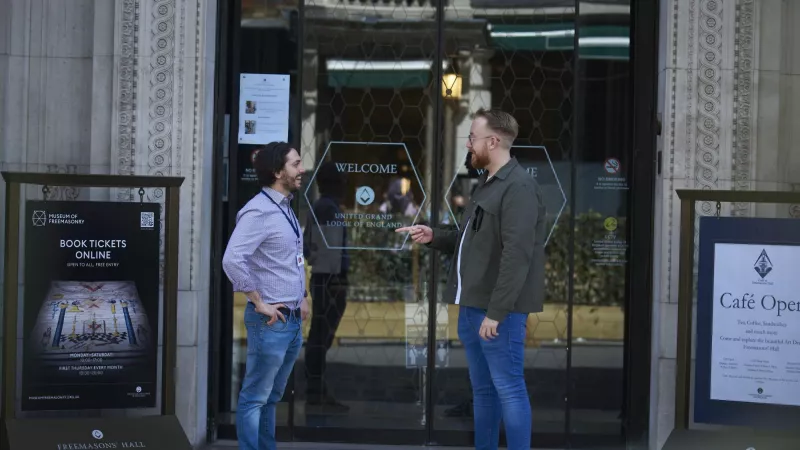 Employees of United Grand Lodge of England talking in front of Freemasons Hall in London