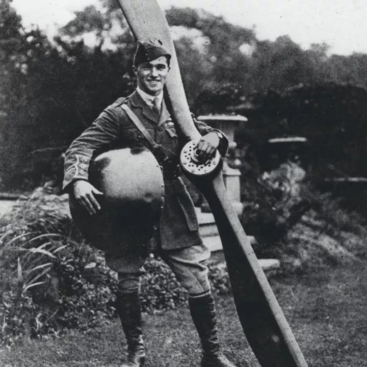 Captain Ball holding the nose and propeller from his plane, c.1917