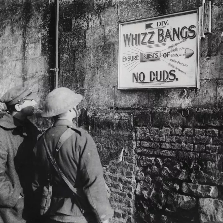 Two British soldiers read an advertisement by 5th Infantry Division for a Christmas Concert Party in Fonquevilliers, France, December 1916