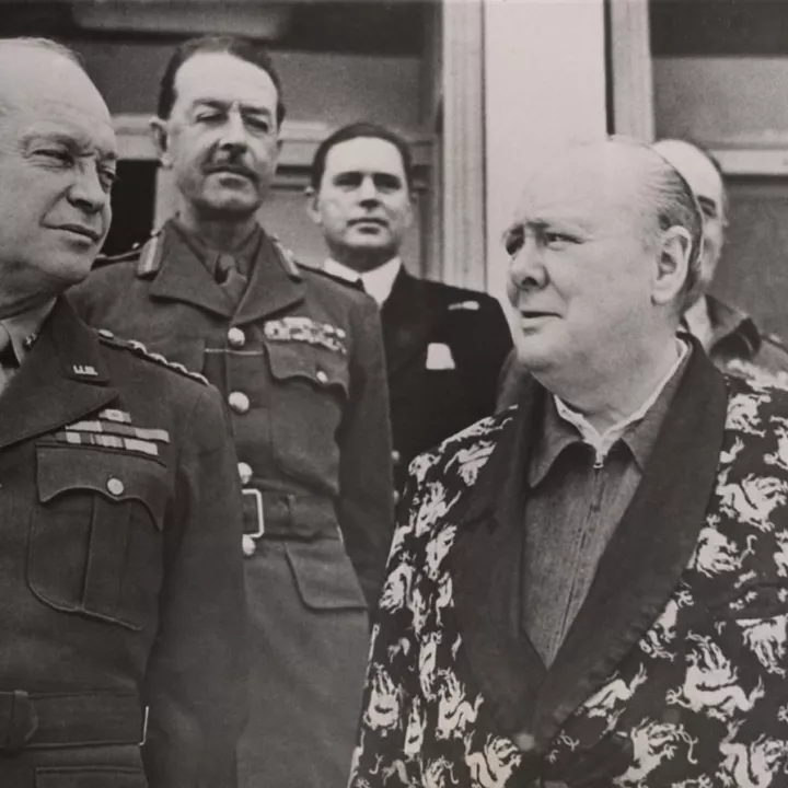 Churchill wearing his famous siren suit with General Dwight D. Eisenhower and General Sir Harold Alexander on Christmas Day 1943