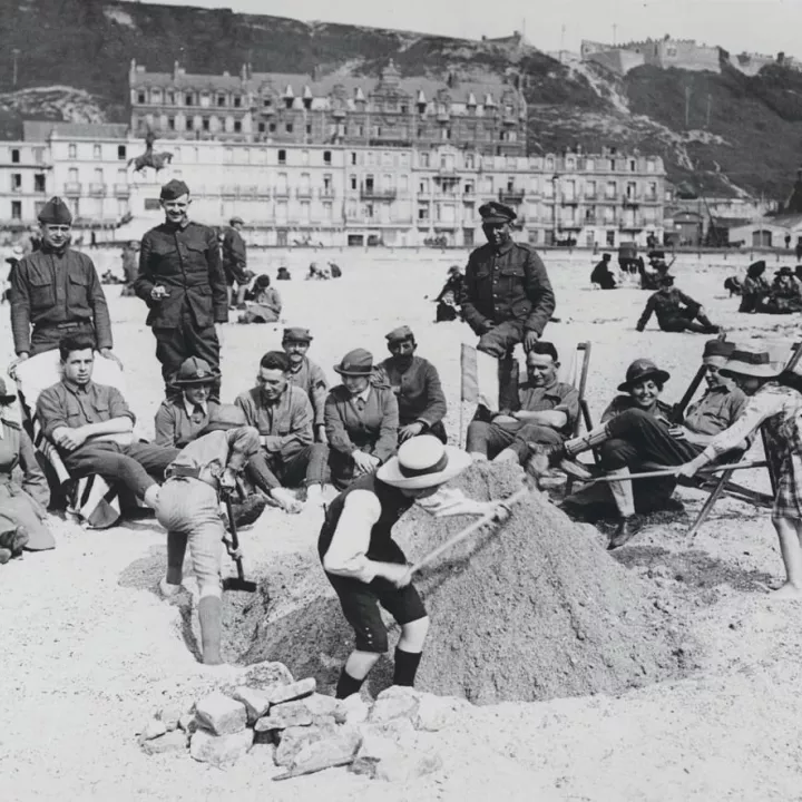 British, American & French troops relaxing on a beach with French children and members of the Women’s Army Auxiliary Corps (WAAC), c.1917