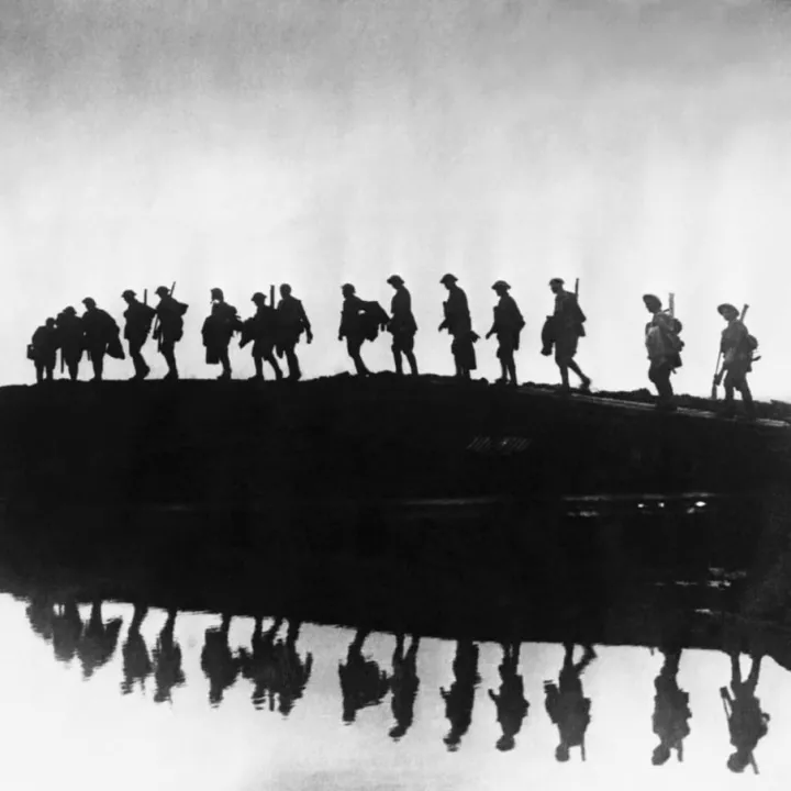 British troops from the East Yorkshire Regiment passing a shell crater, c.1917