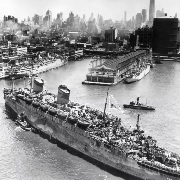 High angle view of a transport ship full of American troops arriving in New York City at end of WWI c.1919